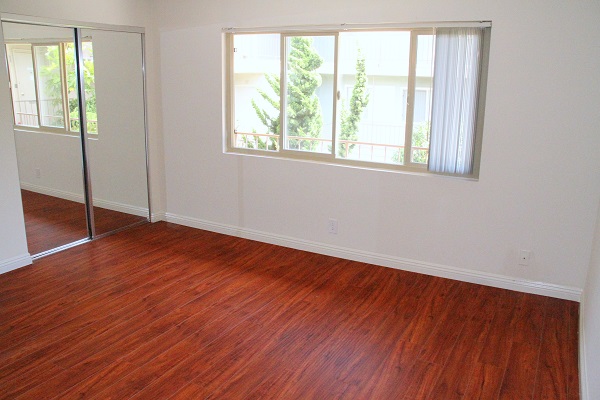 Master Bedroom with Hardwood Floor and Mirrored Closets