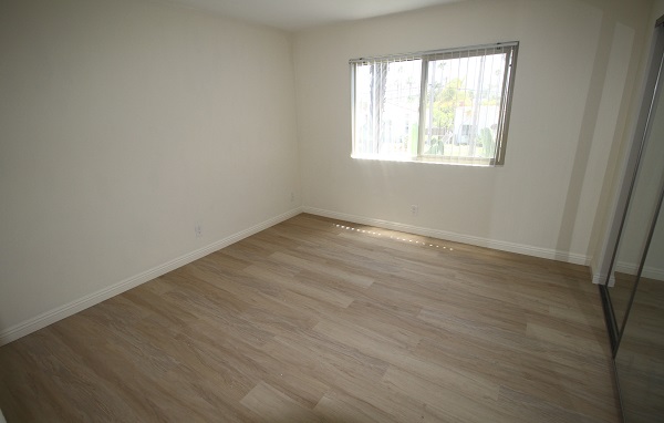 Large Bedroom with wall to wall mirrored closets