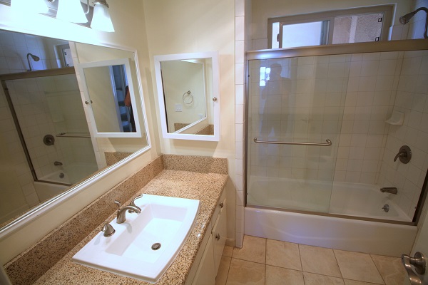 Upper full bathroom with granite counters and Travertine tile