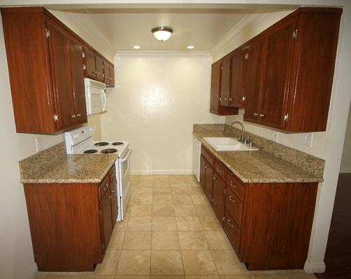 upgraded kitchen with granite counters and Travertine marble floor Upgraded kitchen with custom cabinets, imported granite counters and Travertine marble floor