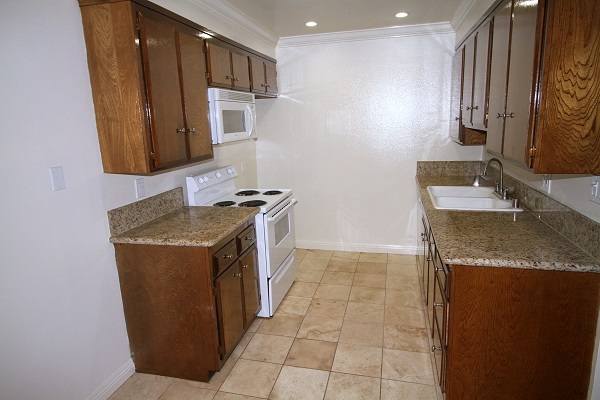 upgraded kitchen with granite counters and Travertine marble floor Upgraded kitchen with custom cabinets, imported granite counters and Travertine marble floo