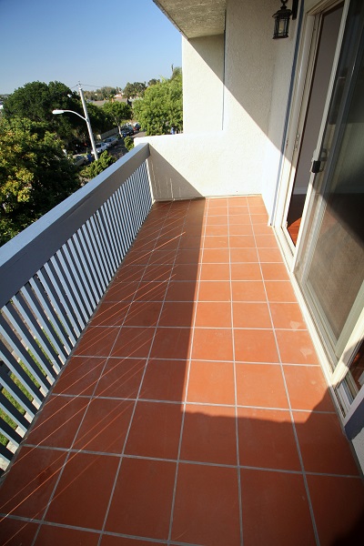 Large balcony off the living room with Terra Cotta tile