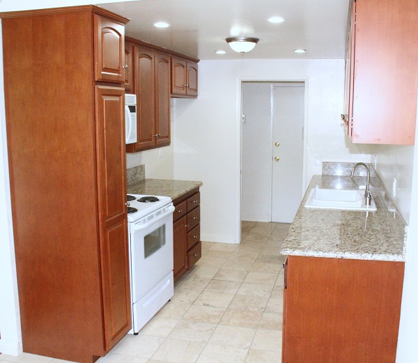 Kitchen with new Custom Cherry wood cabinets, granite and Travertine marble 