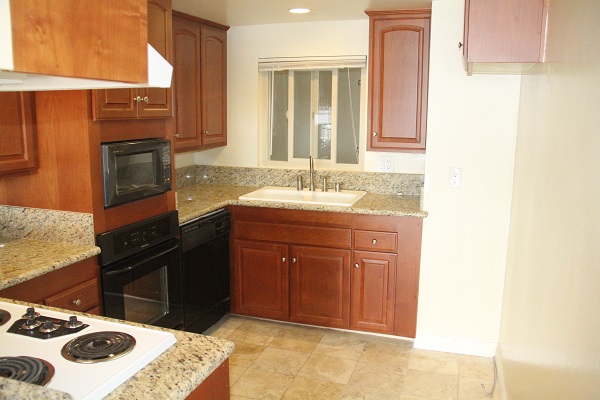 Upgraded kitchen with custom  cabinets, imported granite counters and Travertine marble floor