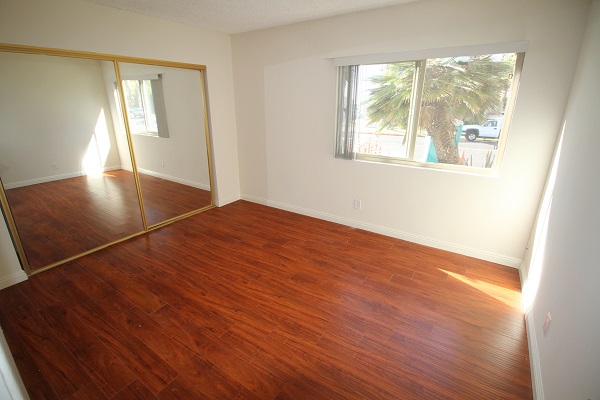 Bedrooms with large closets and hardwood laminate floor