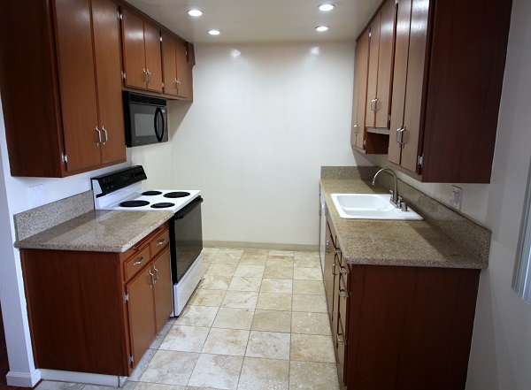 Remodeled kitchen with imported granite counters and Travertine floor