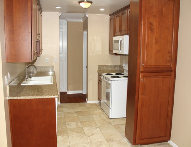 Kitchen with custom cherry wood cabinets, granite and marble