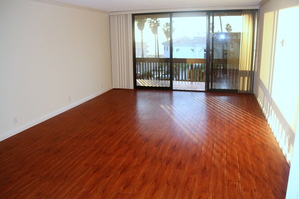 Extra Large Living Room with hardwood Floor and Ocean View Leading to Large Balcony